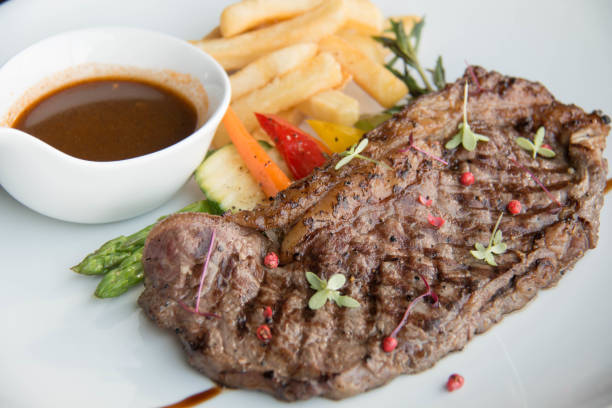 istock Beef steak with sauce on white plate 900395176