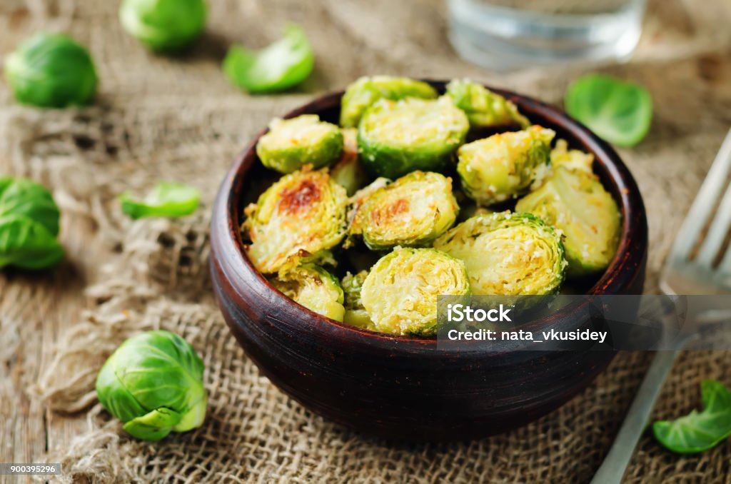 Parmesan Roasted Brussel Sprouts Parmesan Roasted Brussel Sprouts on a wood background. toning. seletive focus Brussels Sprout Stock Photo