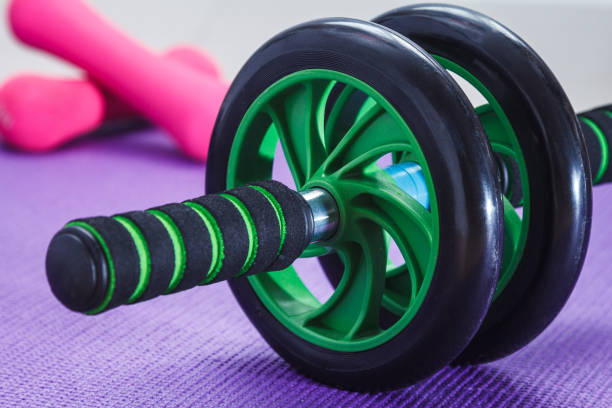 istock Ab roller, dumbbells and yoga mat 900395360