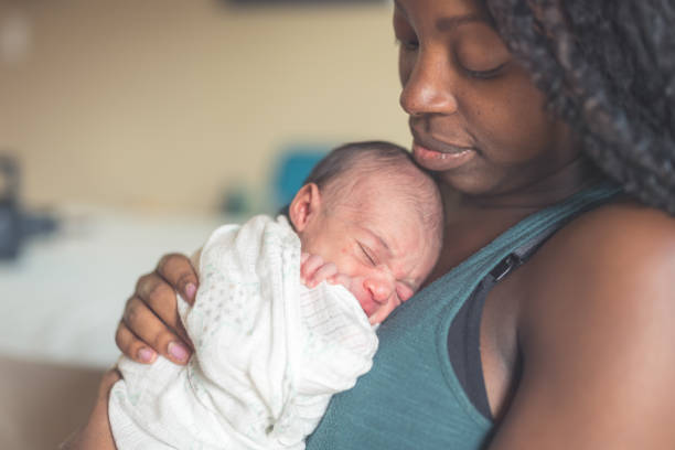 istock New Mom Holding Infant Daughter 900404672