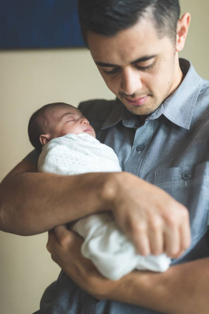 istock New Dad Holding Infant Daughter 900404686