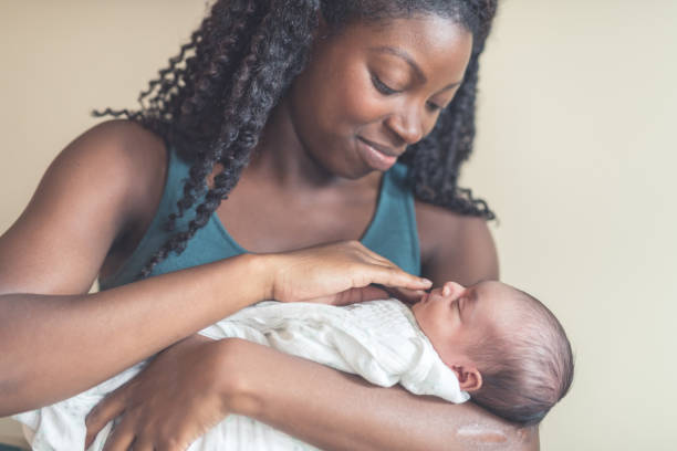 istock New Mom Holding Infant Daughter 900404692