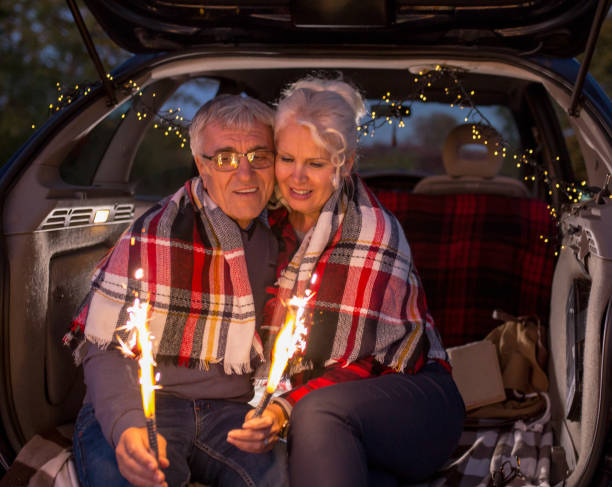 istock Senior couple outdoors with car 900405126