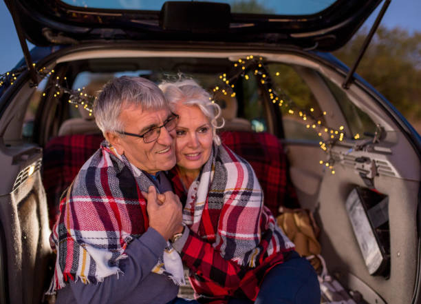 istock Senior couple outdoors with car 900405302