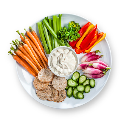 Multi vegetables dip in a plate shot from above isolated on white background.