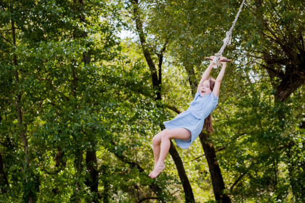 istock Cute girl swinging on the tree 900409198