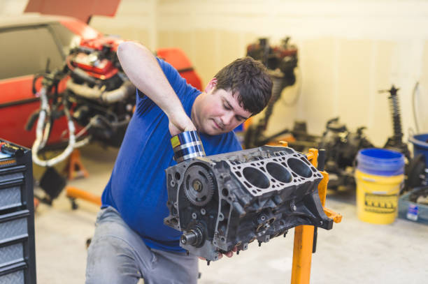 istock Mechanic works on car in his home garage 900416226