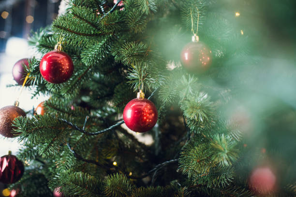 istock Christmas tree with garlands on a brick wall background 900428770