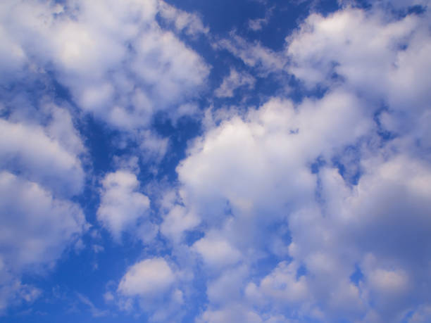 istock White fluffy clouds in the blue sky with morning light 900428848
