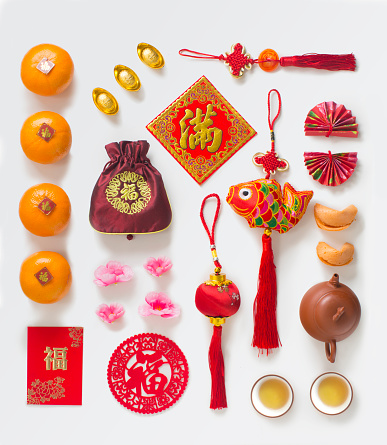 Chinese new year related objects, food and drink still life. Texts appear in image: Prosperity, spring, full, good luck.