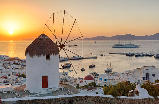Traditional windmill over Mykonos Town at sunset, no people, no wires