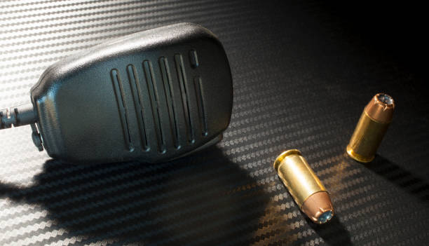 istock Microphone and handgun cartridges 900435098