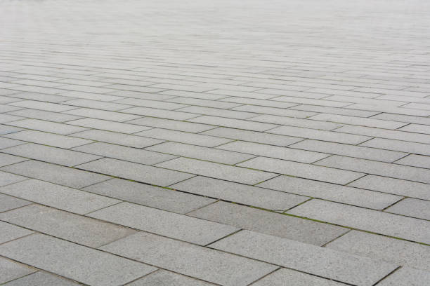 istock Grey brick stone street road. Light sidewalk, pavement texture 900439296