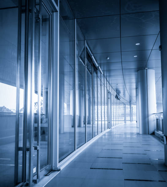 istock Perspective of corridor at the modern office building 900439612