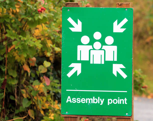 istock Close up on a  green and white Assembly Point sign 900443490