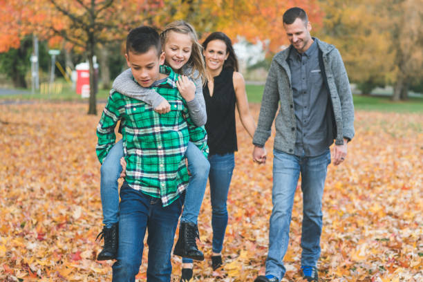 istock Family Walk Through the Leaves 900446868