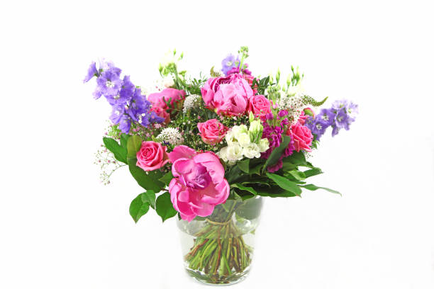 Beautiful bouquet of colorful spring flowers in a vase on white background