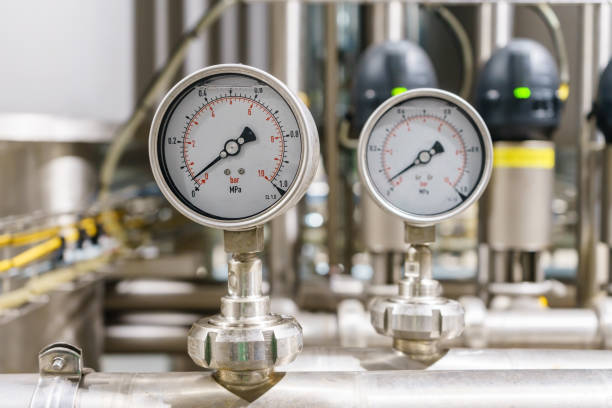 istock Pressure gauge, measuring instrument close up on pneumatic control system. 900454432