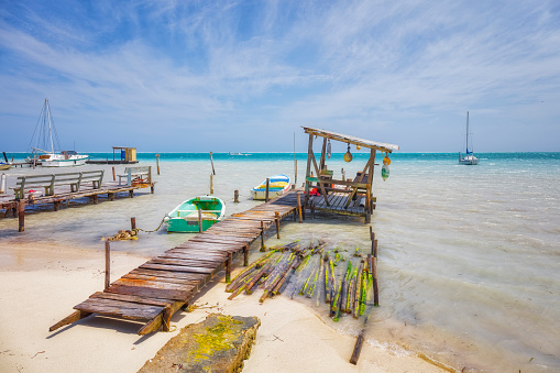 Caye Caulker is a small limestone coral island off the coast of Belize in the Caribbean Sea measuring about 5 miles (8.0 km) (north to south) by less than 1 mile (1.6 km) (east to west). The town on the island is known by the name Caye Caulker Village.