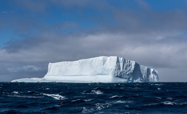 istock Massive tabular iceberg floating in the Southern Ocean in Antarctica 900458812