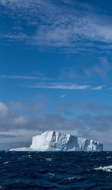 istock Massive tabular iceberg floating in the Southern Ocean in Antarctica 900458904