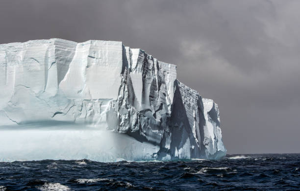 istock Massive tabular iceberg floating in the Southern Ocean in Antarctica 900459058