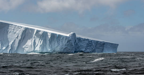 istock Massive tabular iceberg floating in the Southern Ocean in Antarctica 900459212