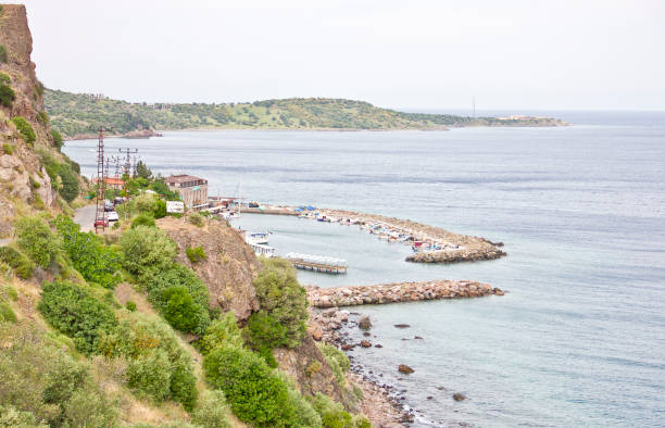Сanakkale, Turkey - May 16, 2017: Ancient assos harbour near the athena temple. There are lots of boat near the fish restaurants. Tourists visit assos town near Aegean Sea Coast, Assos also known as Behramkale or for short Behram, is a small historically rich town in the Ayvacık district of the Canakkale Province.