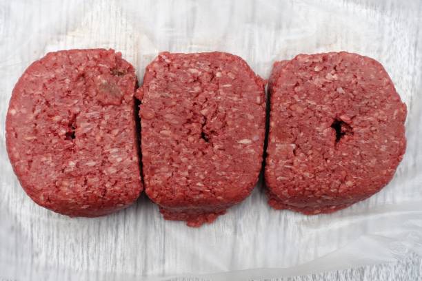 istock Fresh ground beef on plastic wrap paper on Kitchen counter 900466606