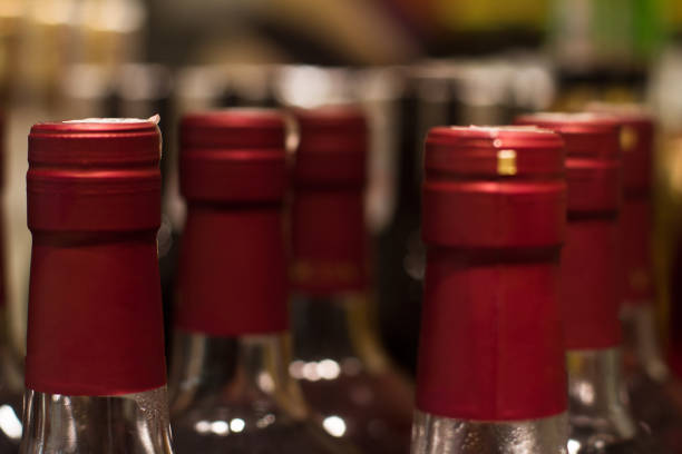 istock red wine bottles in store 900468390