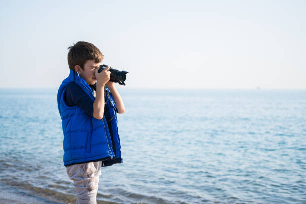 istock Happy  photographer Boy walking on the beach on a Winter's Day 900485568