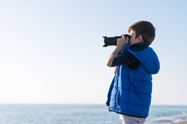 istock Happy  photographer Boy walking on the beach on a Winter's Day 900485714