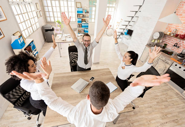 istock Team of young people holding hands, high angle view 900505980