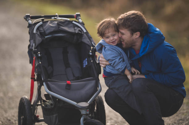 istock Dad Taking His Son for a Walk in the Stroller 900509694