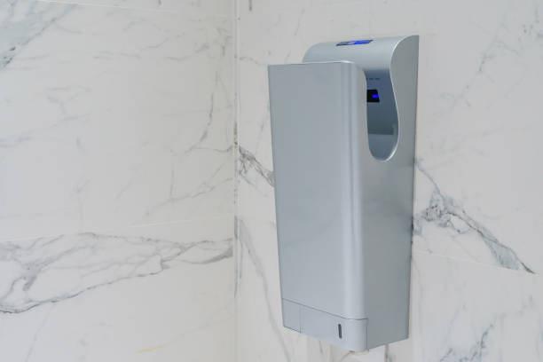 istock Modern vertical hand dryer in public restroom WC 900517338