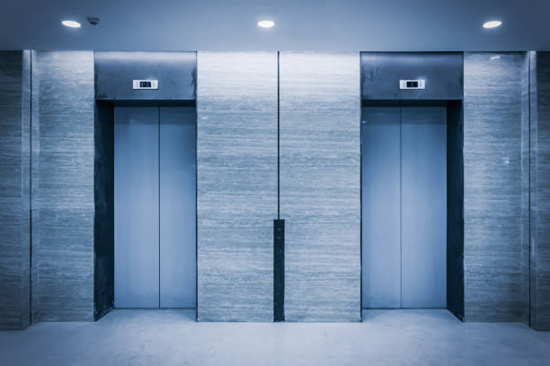 istock An empty modern elevator or lift with metal doors that are open in building with lighting. 900538316