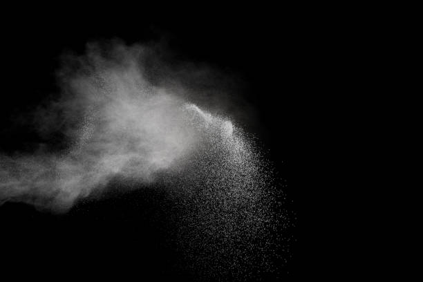 istock Launched white powder splash on black background. Bizarre forms of of white powder explosion cloud against dark background. 900550018
