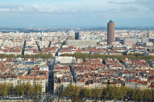 Wide panorama aerial view of Lyon cityscape with Saone and Rhone river, La Part-Dieu business district skyscrapers and buildings in background and hostoric monuments like St Jean Cathedral from Vieux Lyon district. Photo taken in Lyon famous city, Unesco World Heritage Site, in Rhone department, Auvergne-Rhone-Alpes region in France, Europe during a sunny summer day.