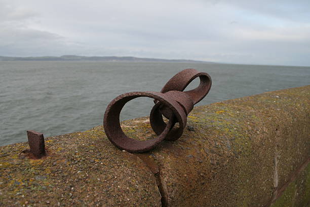 Rusty Metal on sea wall stock photo