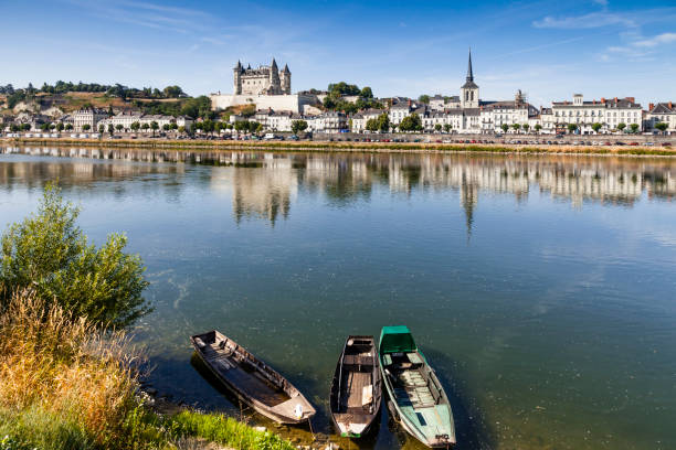 The town of Saumur reflecting in the River Loire on a sunny summer morning.