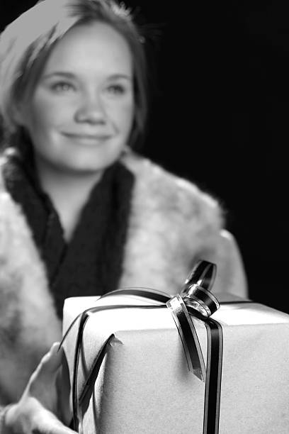 girl holding gift stock photo