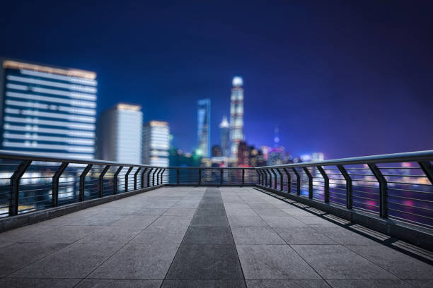 Empty floor with modern skyline and buildings at night in Shanghai