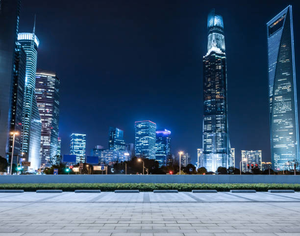 istock Panoramic empty floor with modern business office building at night 900558078