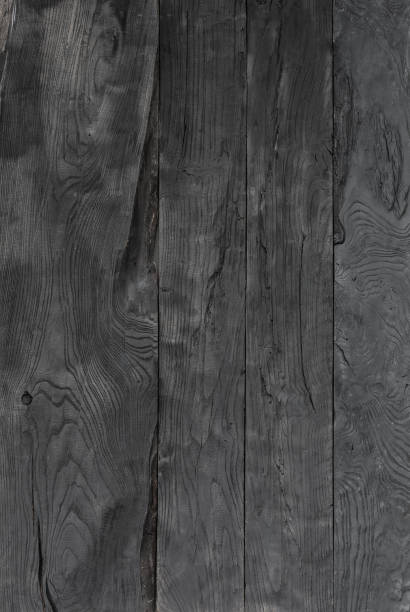 istock old black weathered rough board, rustic wooden background 900558556