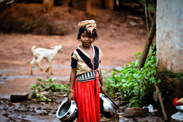 Child labour rural girl holding water vessels to store water child labor stock pictures, royalty-free photos & images