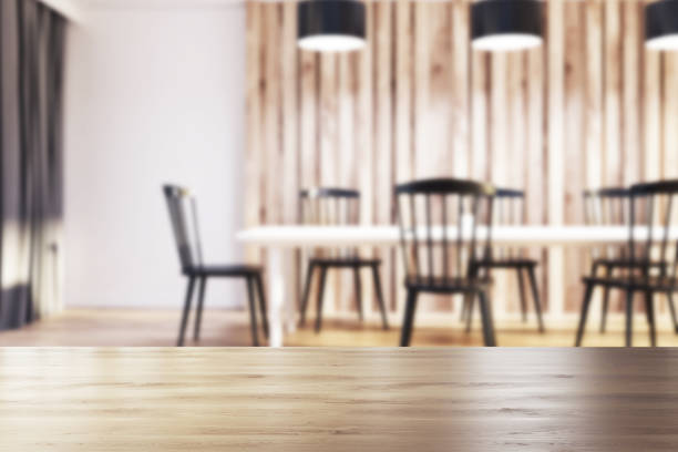 istock White and wooden dining room, black chairs blur 900569266