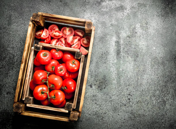 istock Fresh tomatoes in a wooden box. 900569544