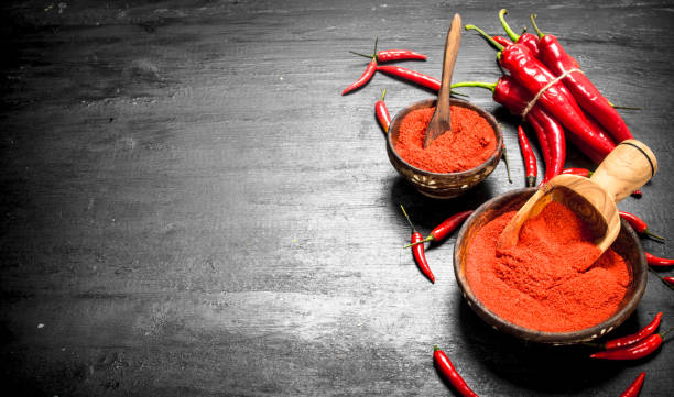istock Ground hot peppers in a wooden bowl. 900569906