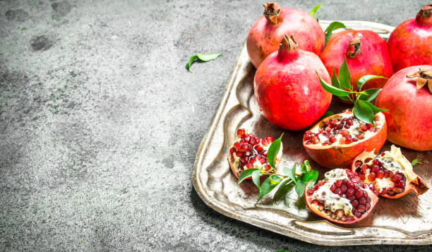 istock Ripe pomegranates on a steel tray. 900572204