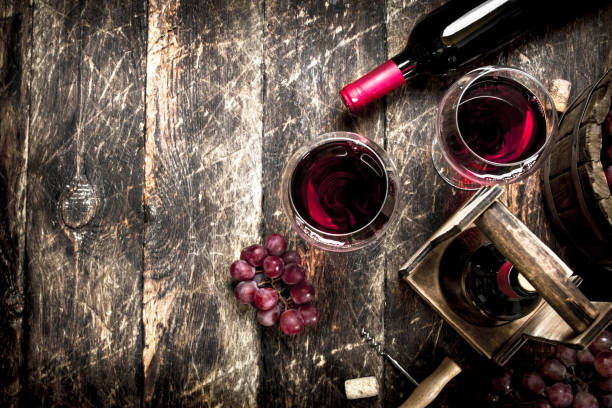 istock Wine background. Red wine with glasses with grapes. 900572466